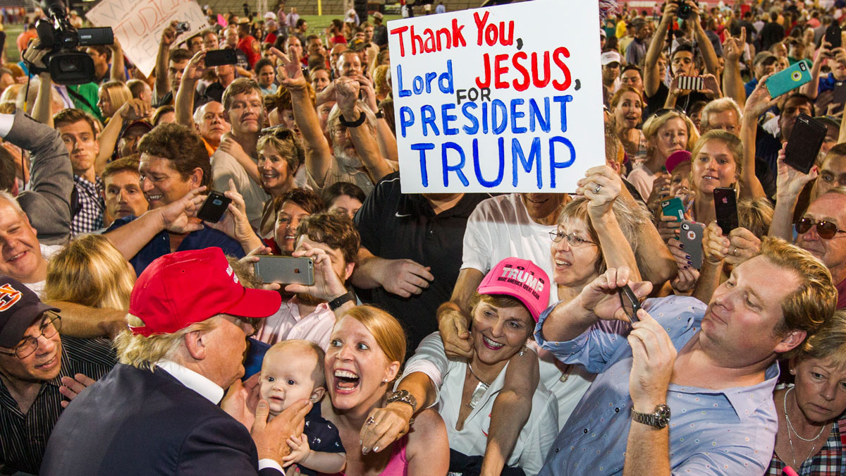 Woman going nuts at a Trump rally, her baby isn't so sure.